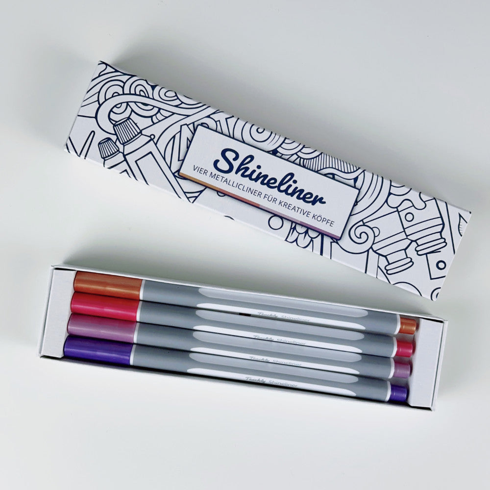 Geöffnete Teachly Shineliner Vintage Verpackung mit den vier Metallic Stiften in den Farben Lila, Violett, Rot und Bronze